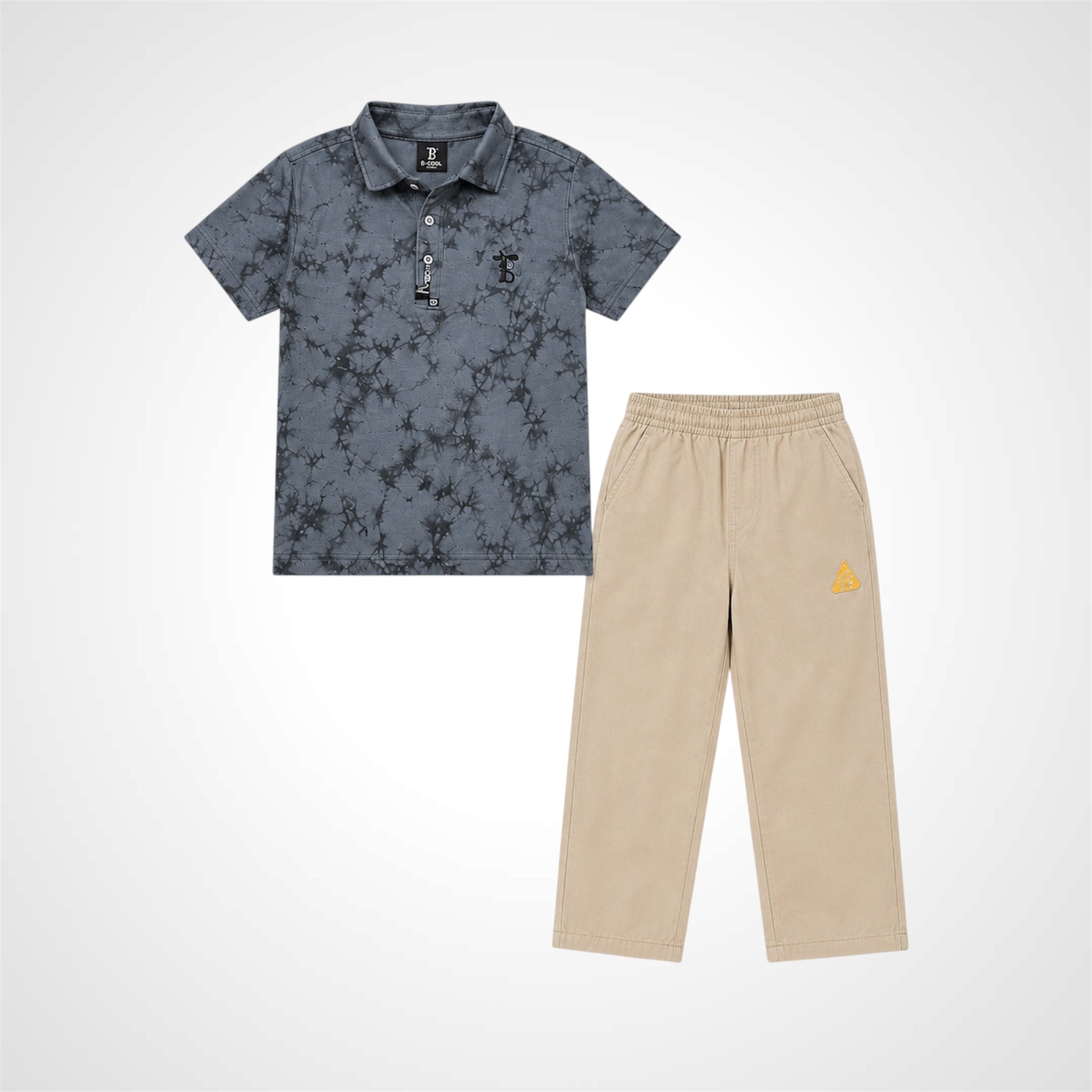 A two-piece kids' outfit set featuring a short-sleeve polo shirt in a slate blue-gray floral pattern and matching beige pants with a small yellow logo on the left thigh, displayed on a light gray background.