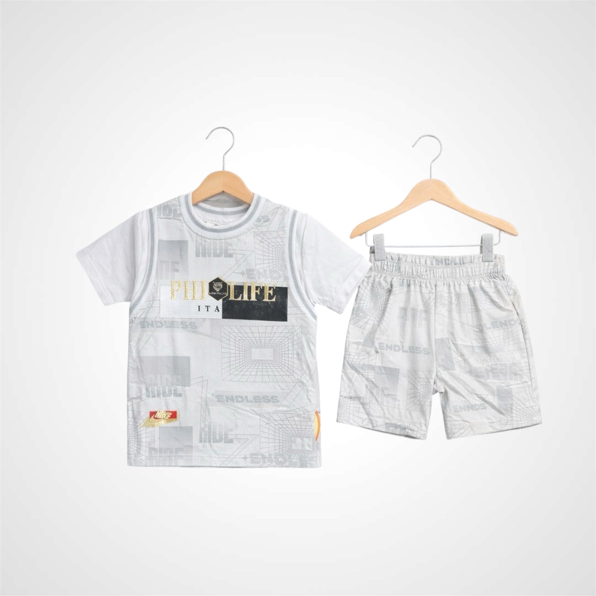 Boys basketball-inspired streetwear outfit featuring a jersey-style graphic t-shirt and athletic shorts on wooden hangers