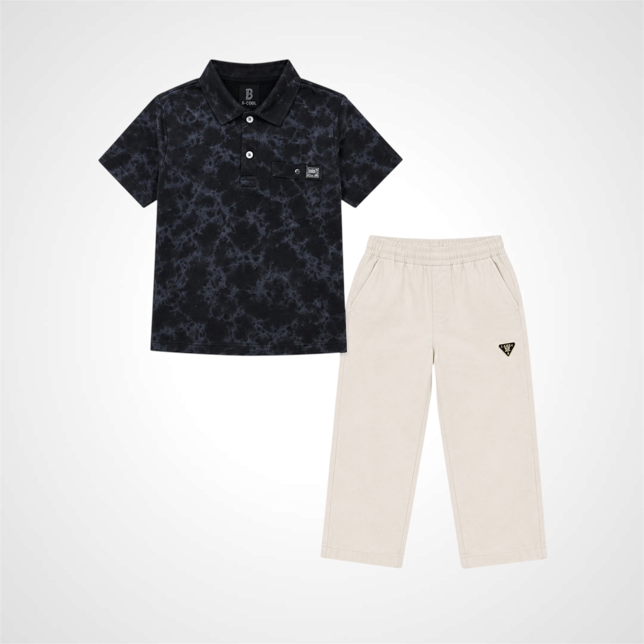 A two-piece kids' outfit set featuring a short-sleeve polo shirt in black with a subtle gray abstract pattern, paired with cream-colored pants that have a small black triangular logo on the left thigh.