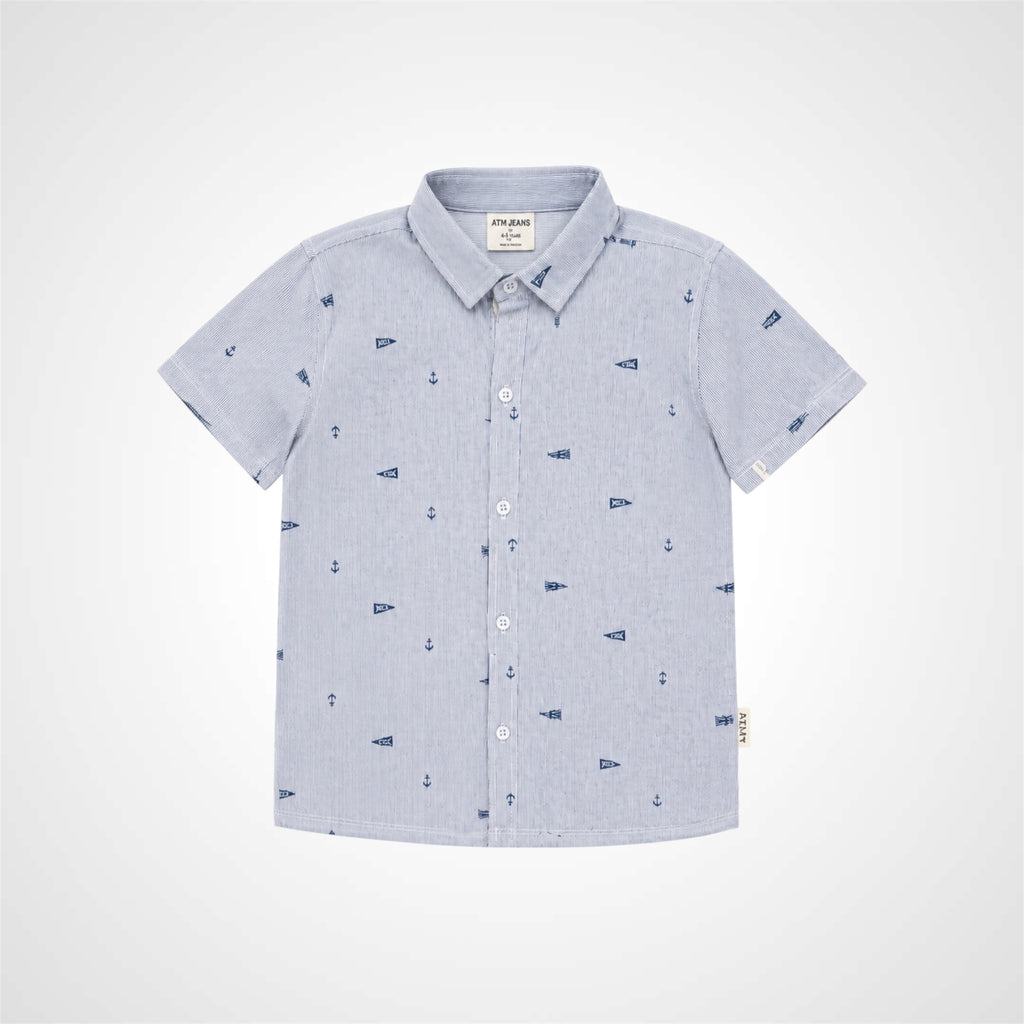 A light blue short-sleeve button-up shirt for kids, featuring a subtle micro-check pattern and a small navy blue anchor print scattered across the front. The shirt is displayed flat against a light gray background.