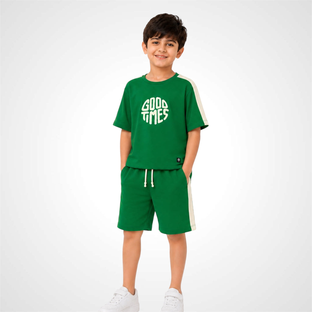 Child wearing a green 'Good Times' outfit on a white background