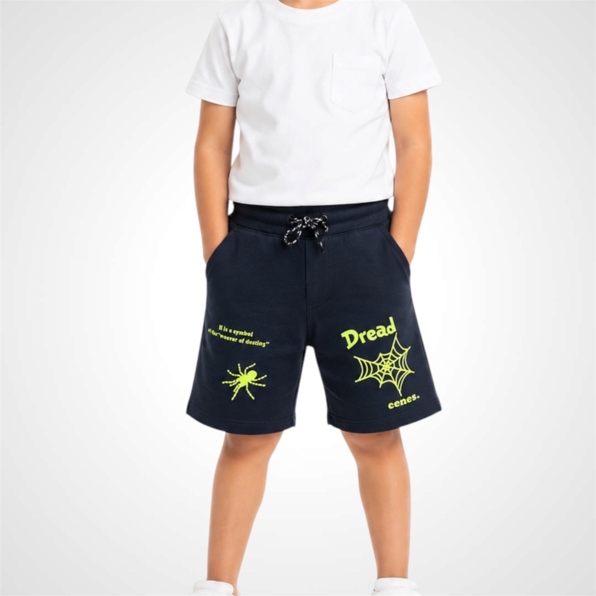 Person wearing navy shorts with yellow text and graphics on a white background