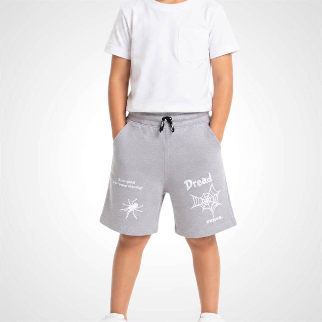 Person wearing gray shorts with white text and designs on a white background