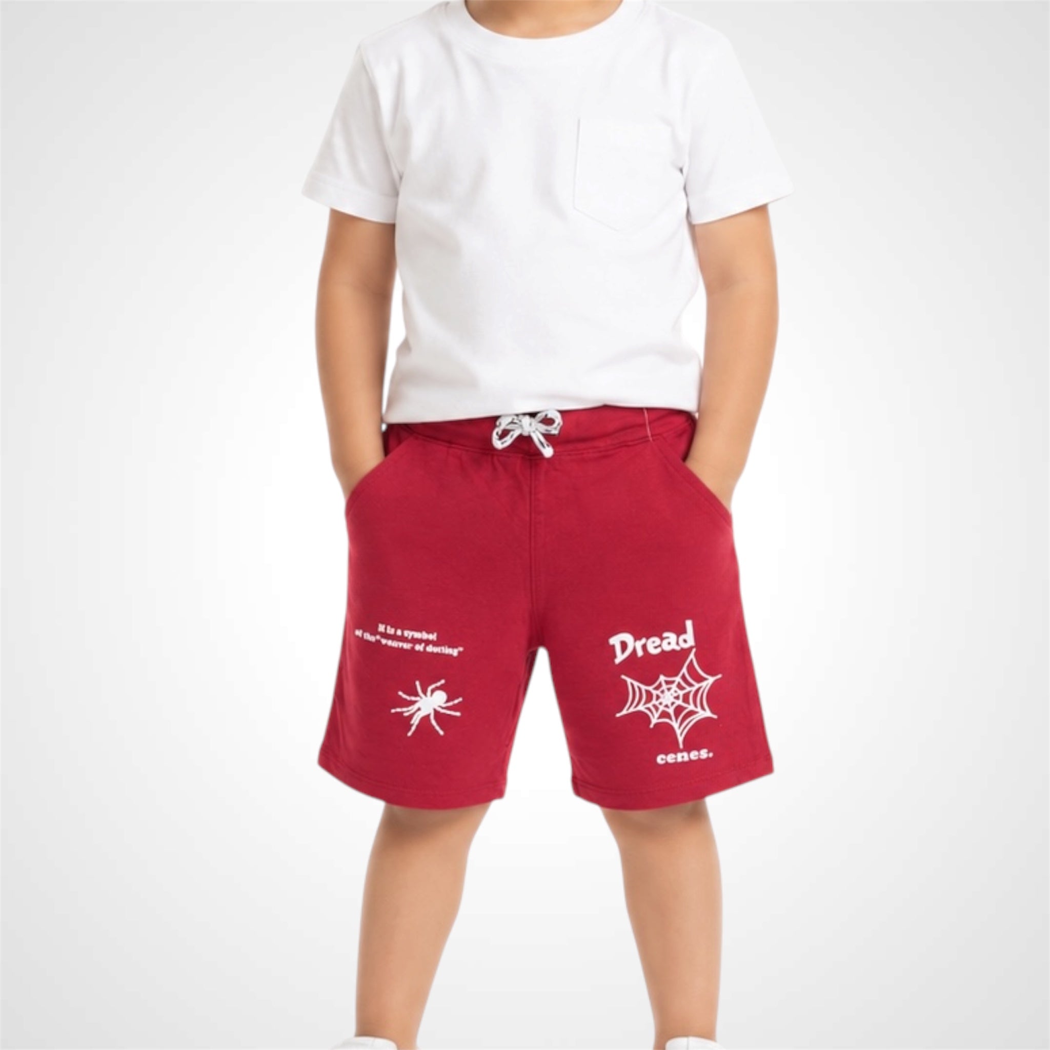 Red shorts with white text and graphics worn by a person on a white background