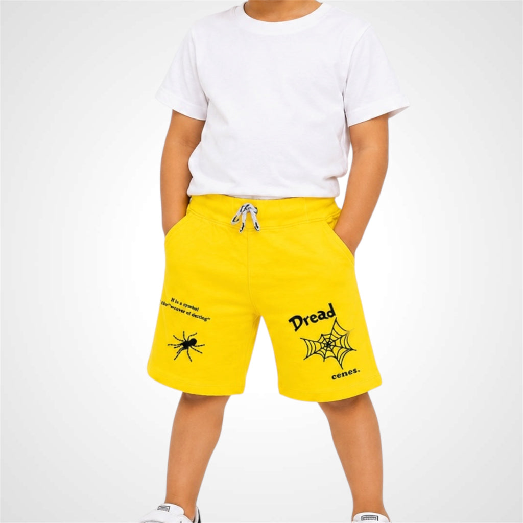 Person wearing yellow shorts with black text and graphics on a white background
