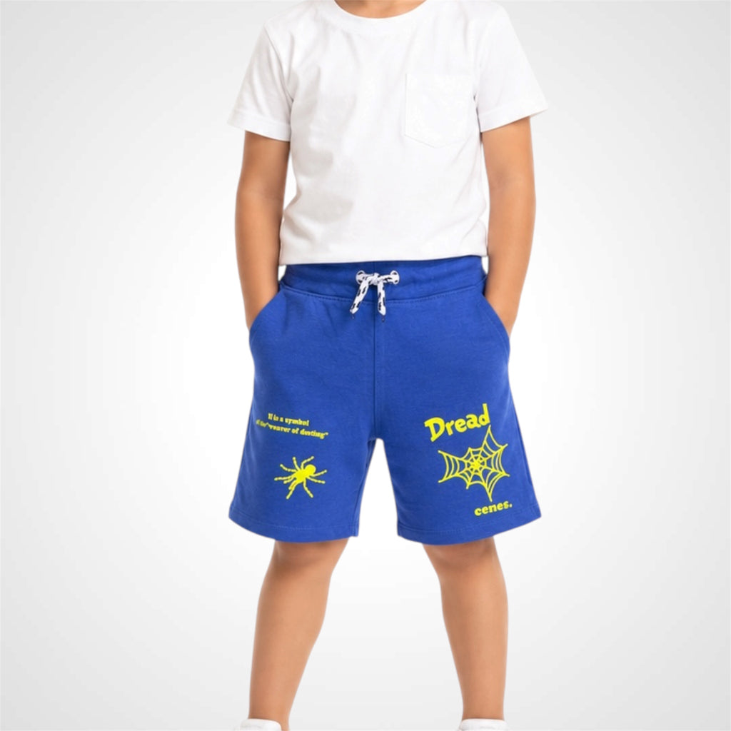 Person wearing blue shorts with yellow text and spider design on a white background