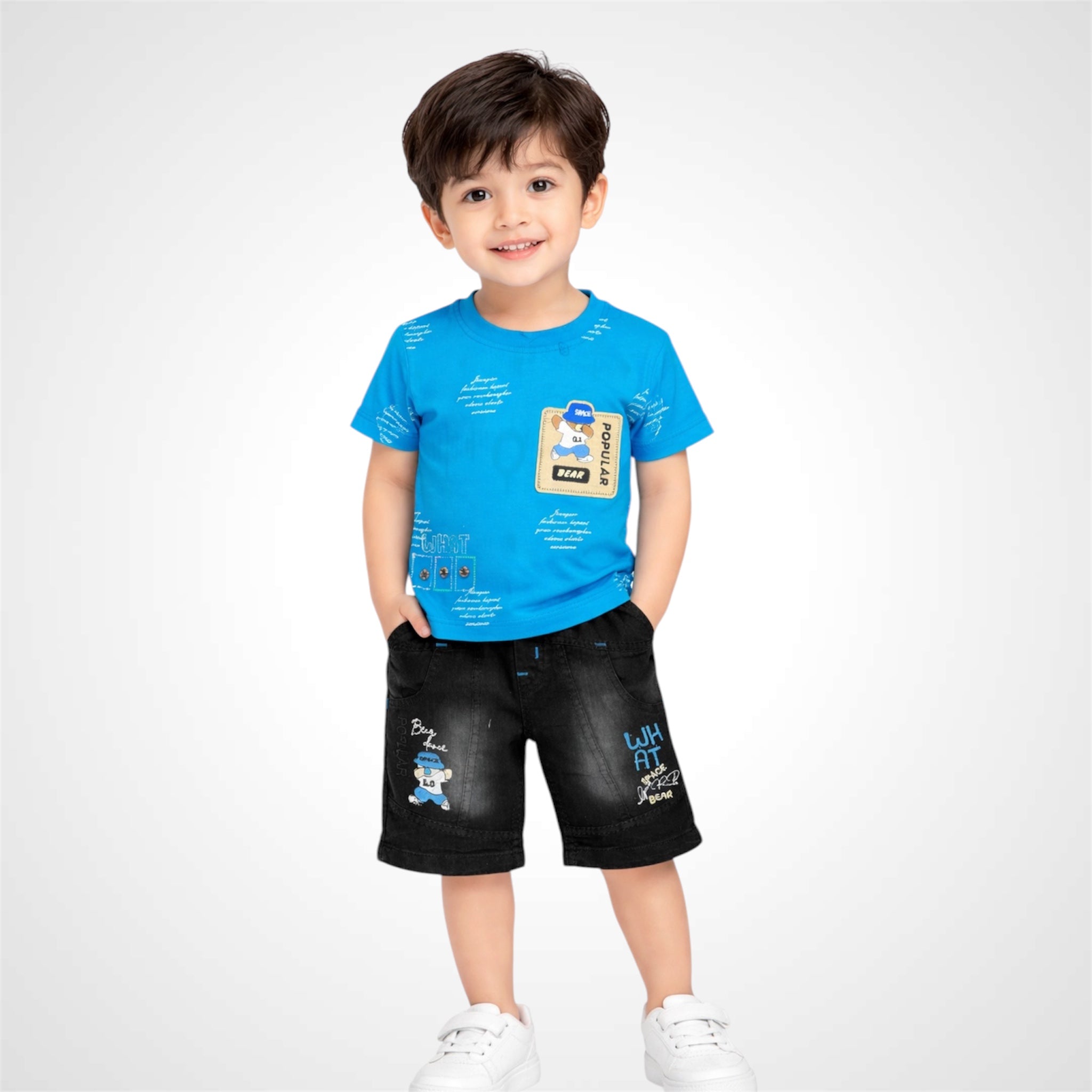 Child wearing a blue t-shirt and black shorts with cartoon character design on a white background