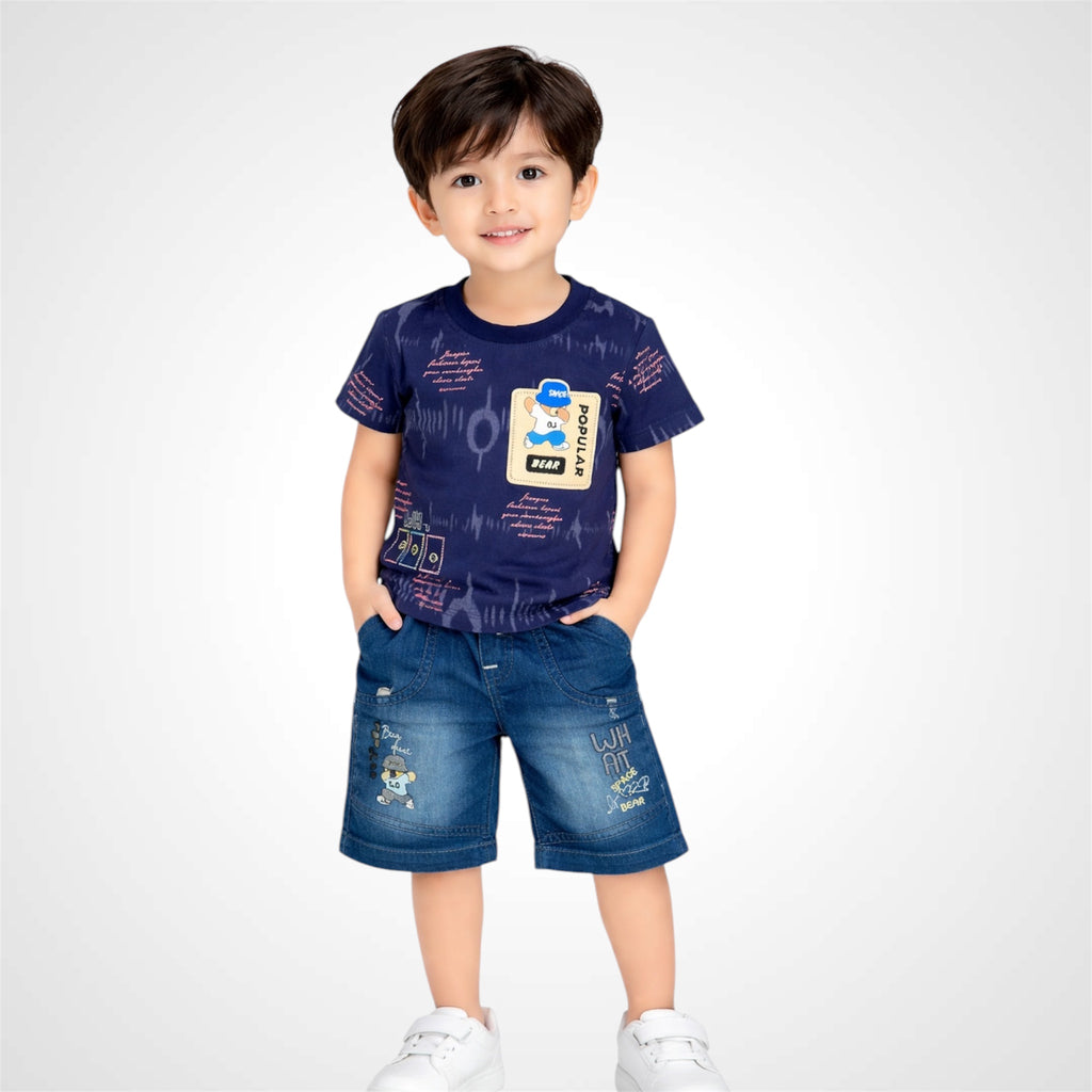 Child wearing a navy blue t-shirt with graphics and denim shorts on a white background