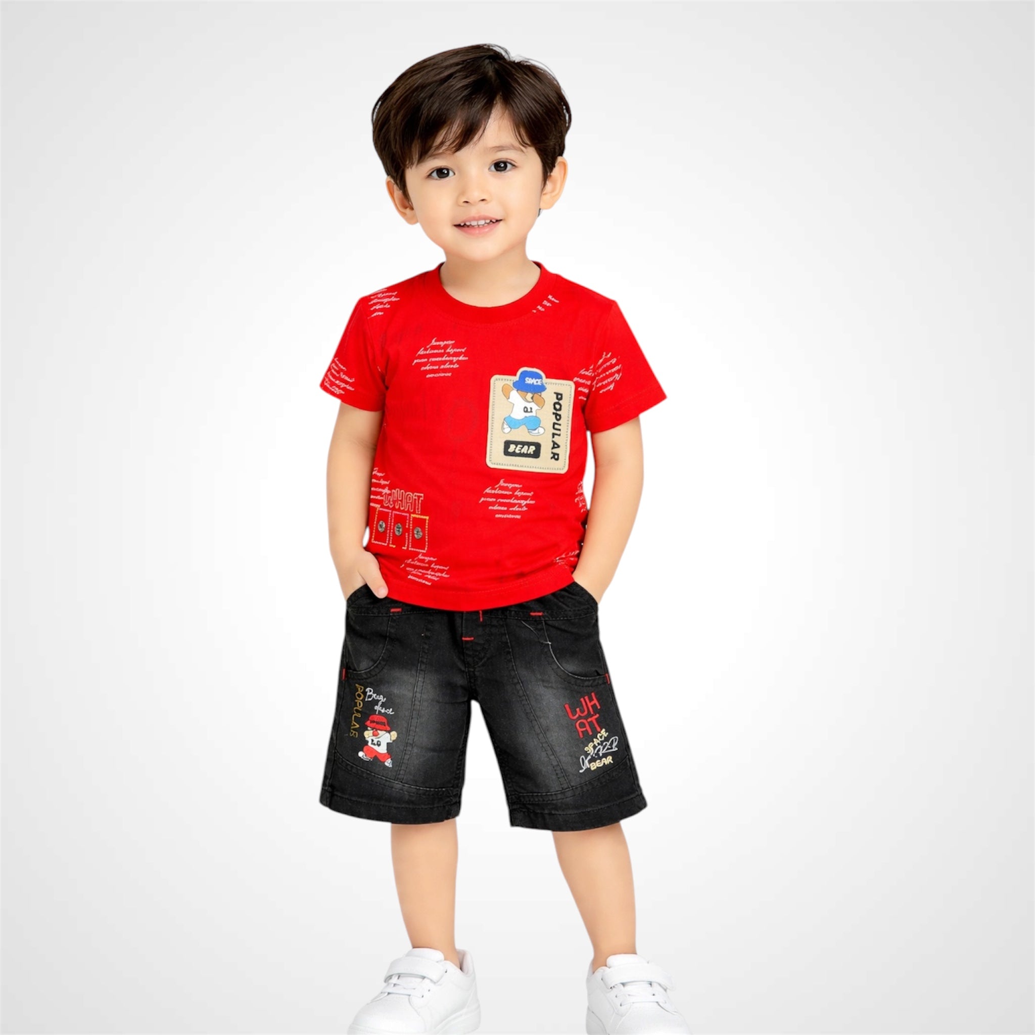 Child wearing a red t-shirt and black shorts on a white background