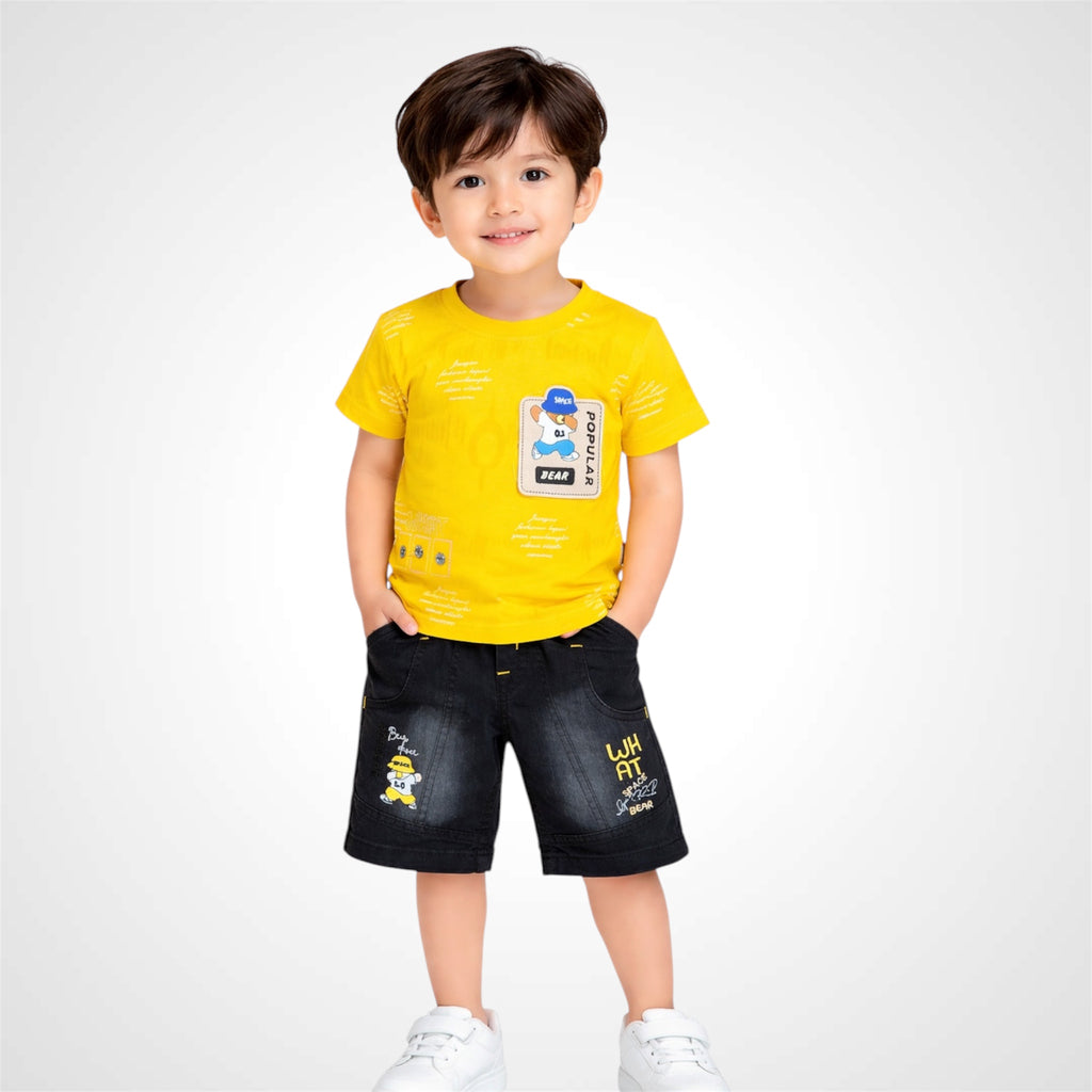 Child wearing a yellow t-shirt and black shorts on a white background