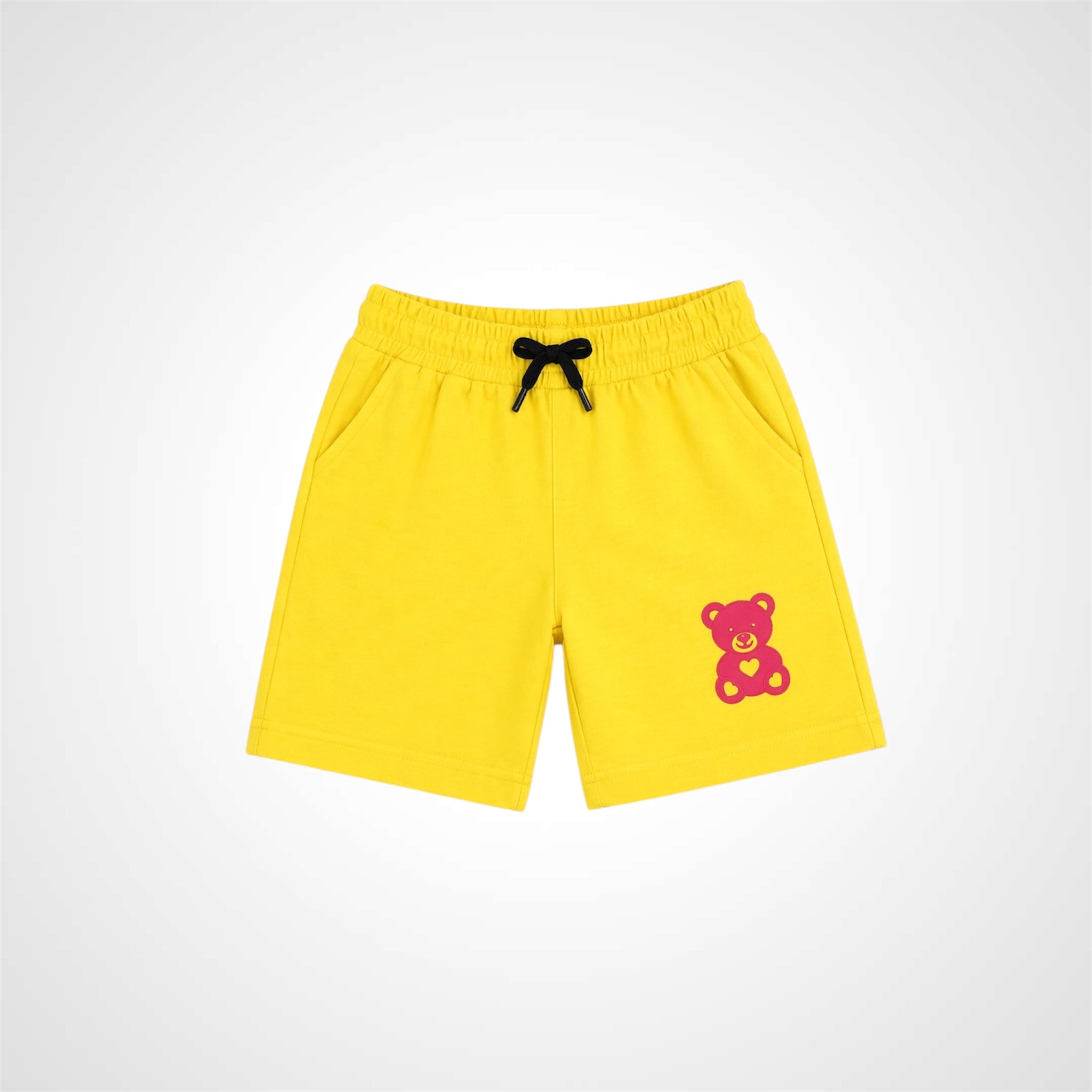 Yellow shorts with a teddy bear design on a white background