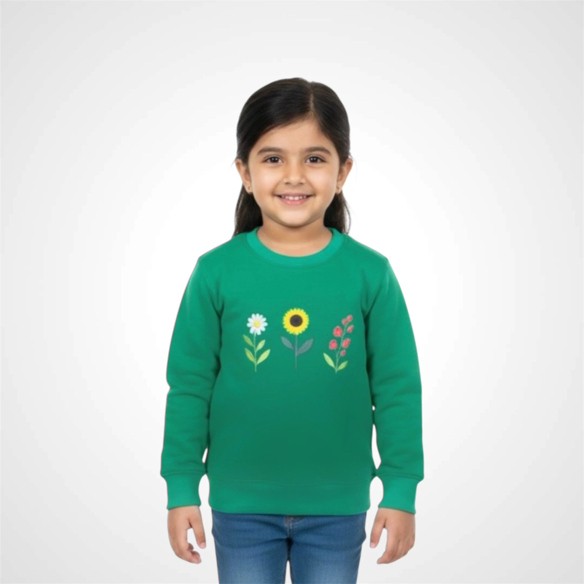 Smiling little girl wearing a kids floral print sweatshirt featuring sunflower, daisy, and berry graphics green