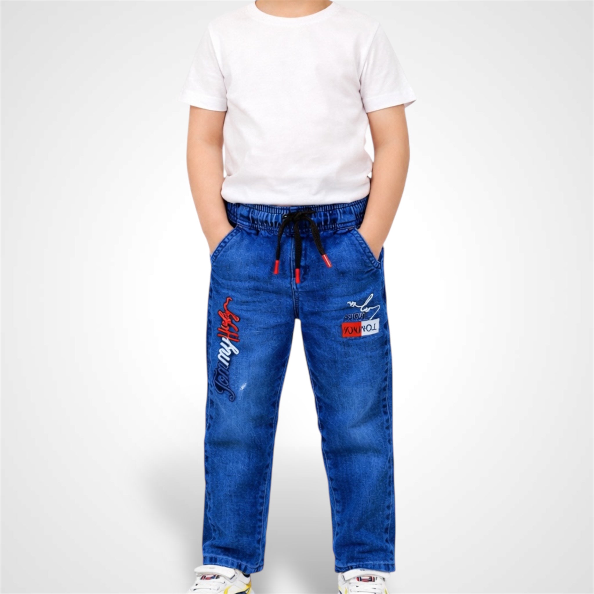 Person wearing blue jeans with red and white designs on a white background