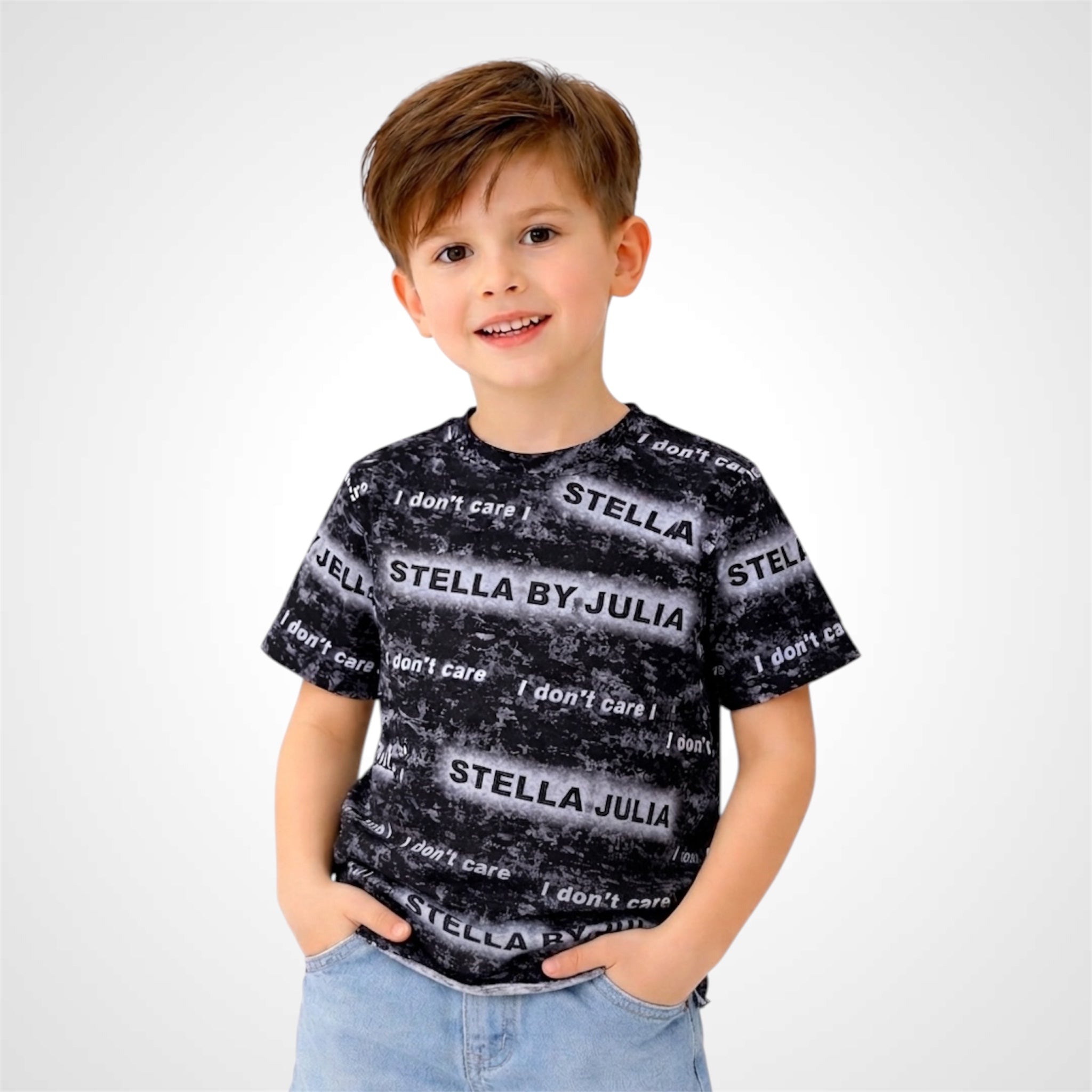 Child wearing a black and gray patterned t-shirt with 'Stella by Julia' text on a white background