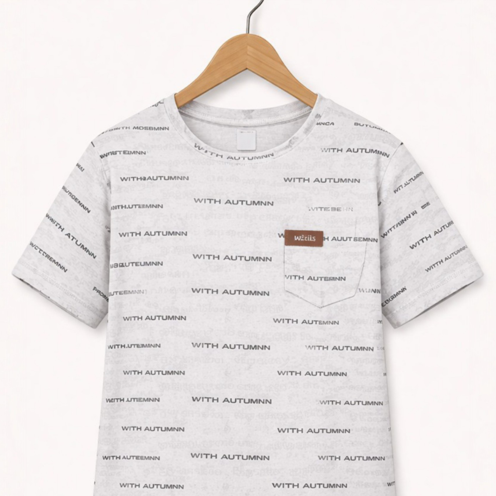 Gray t-shirt with text pattern on a hanger against a white background