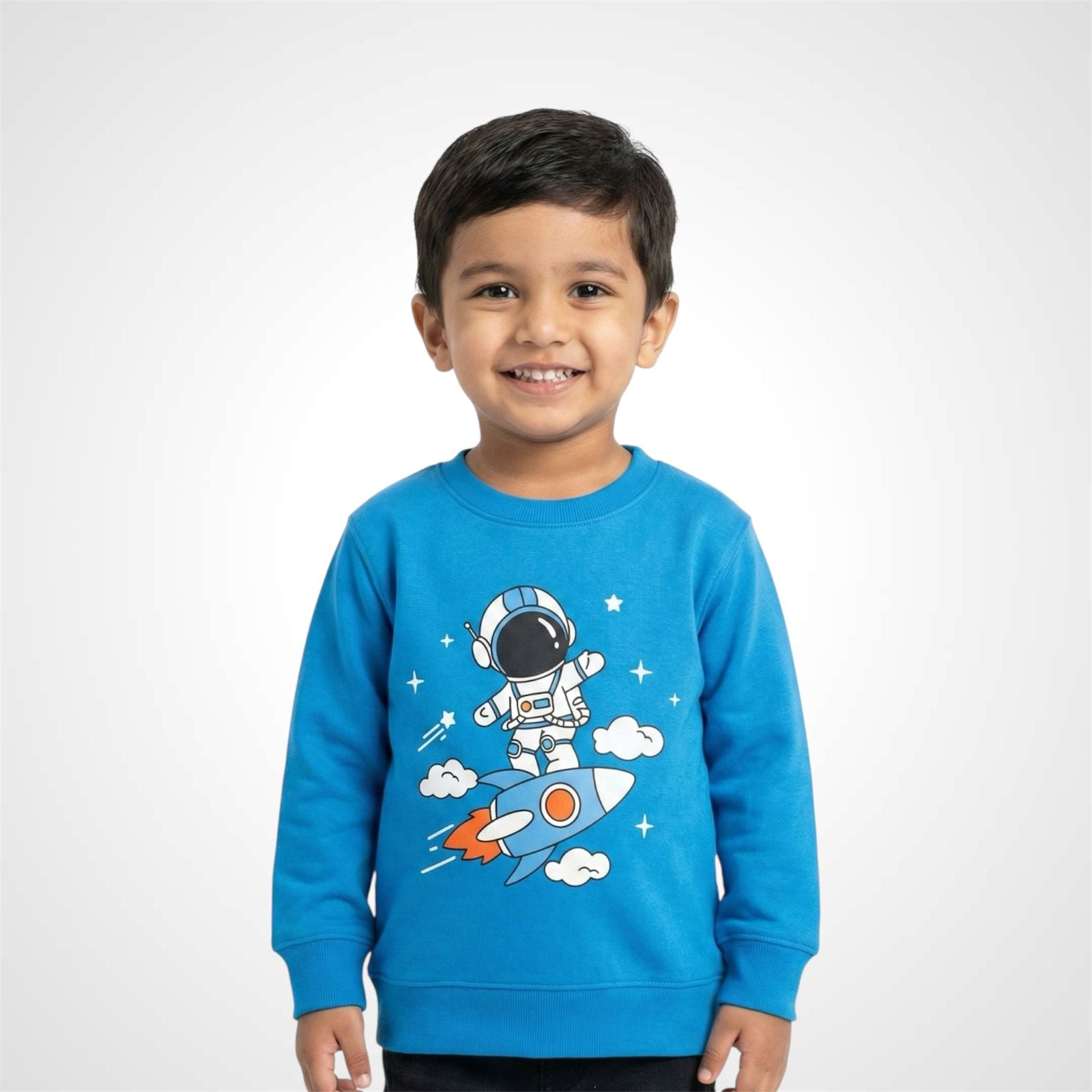 Smiling little boy wearing a grey Toddler & Boys Space Theme Sweatshirt featuring a cute cartoon Astronaut Print riding a rocket blue 
