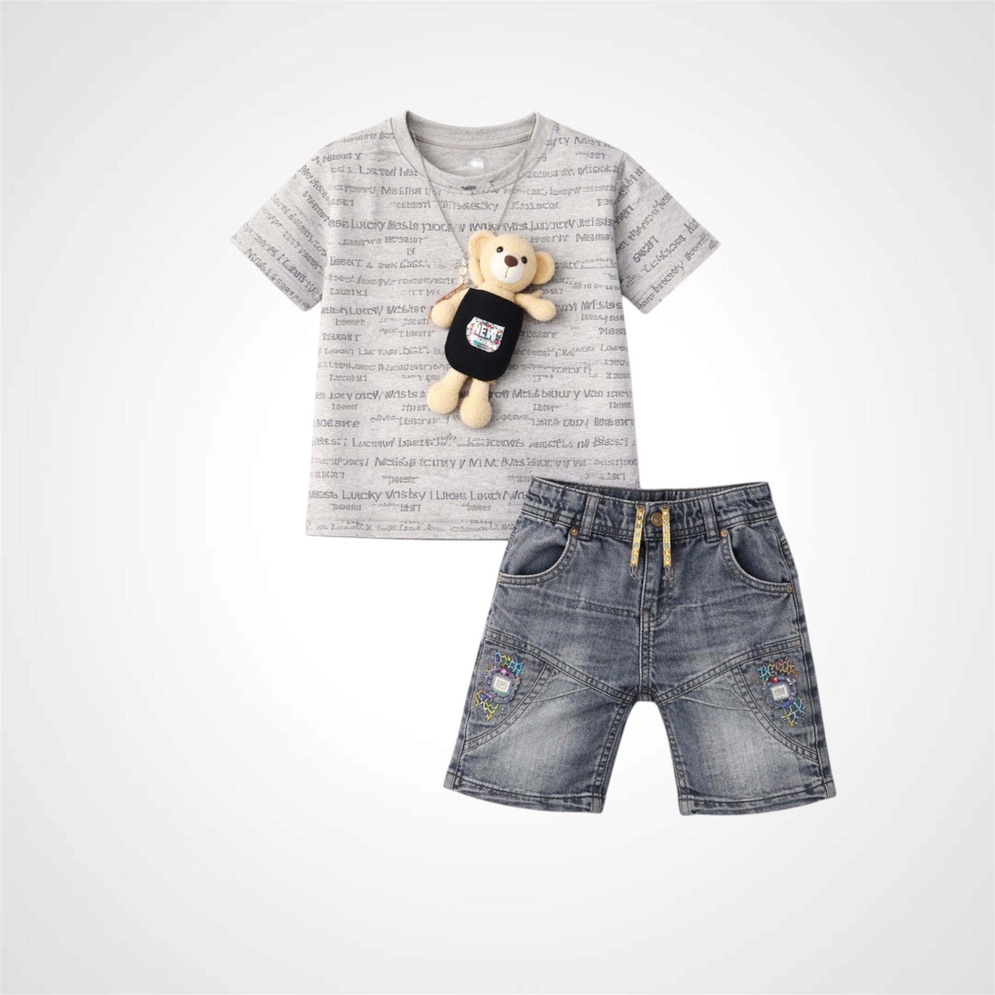 Children's outfit with gray t-shirt, denim shorts, and teddy bear on a white background
