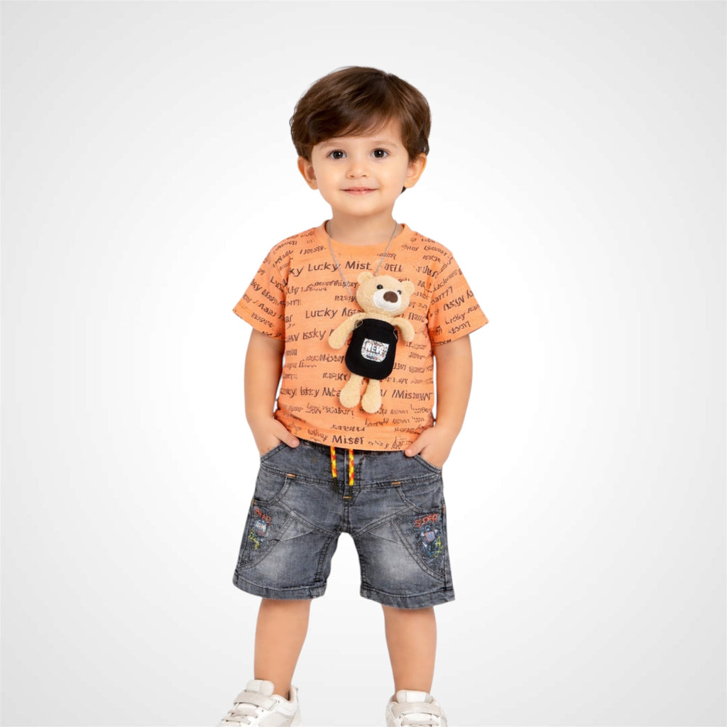 Child wearing an orange t-shirt with text and denim shorts, holding a teddy bear on a white background